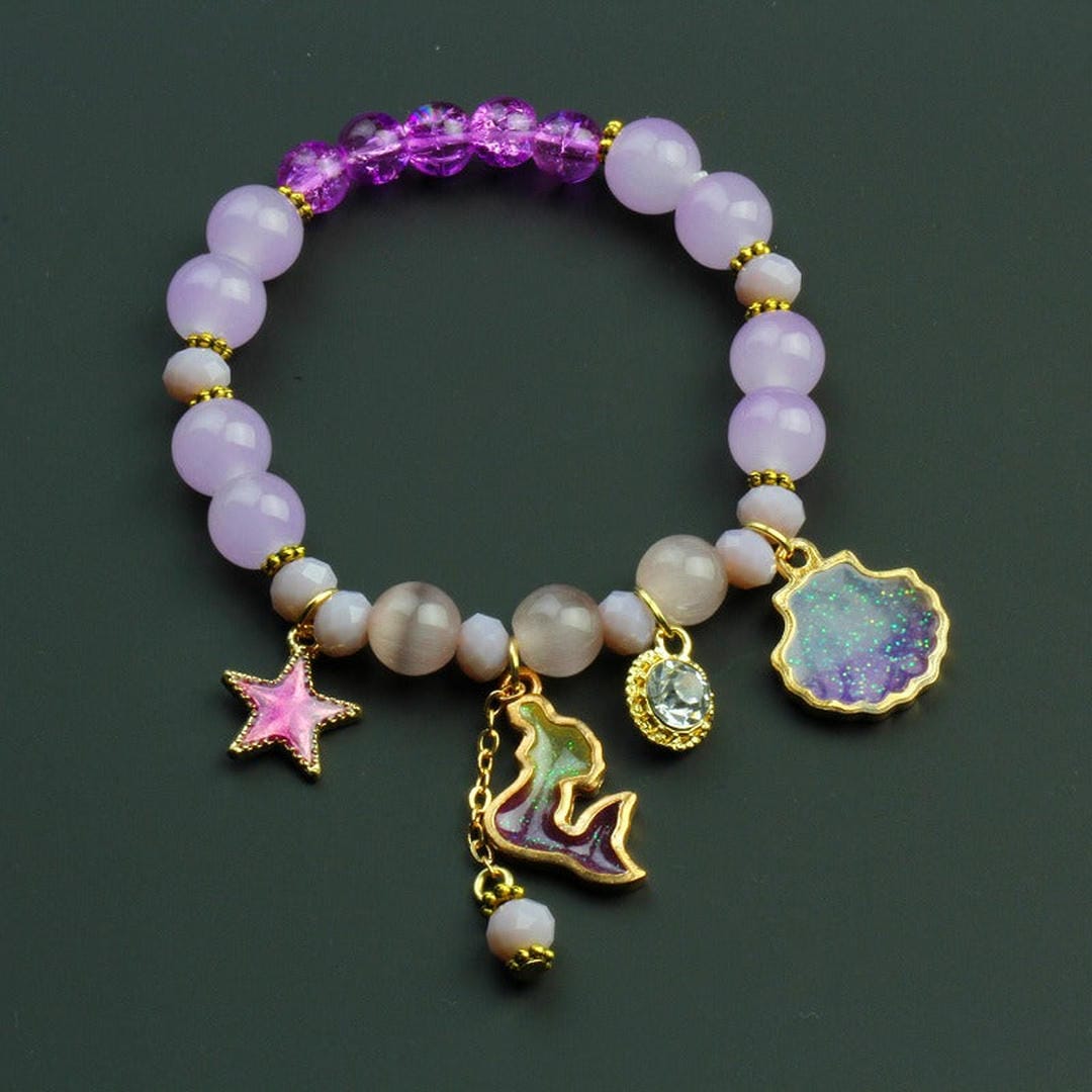 Bracelet en perles avec un charme dauphin et un coquillage