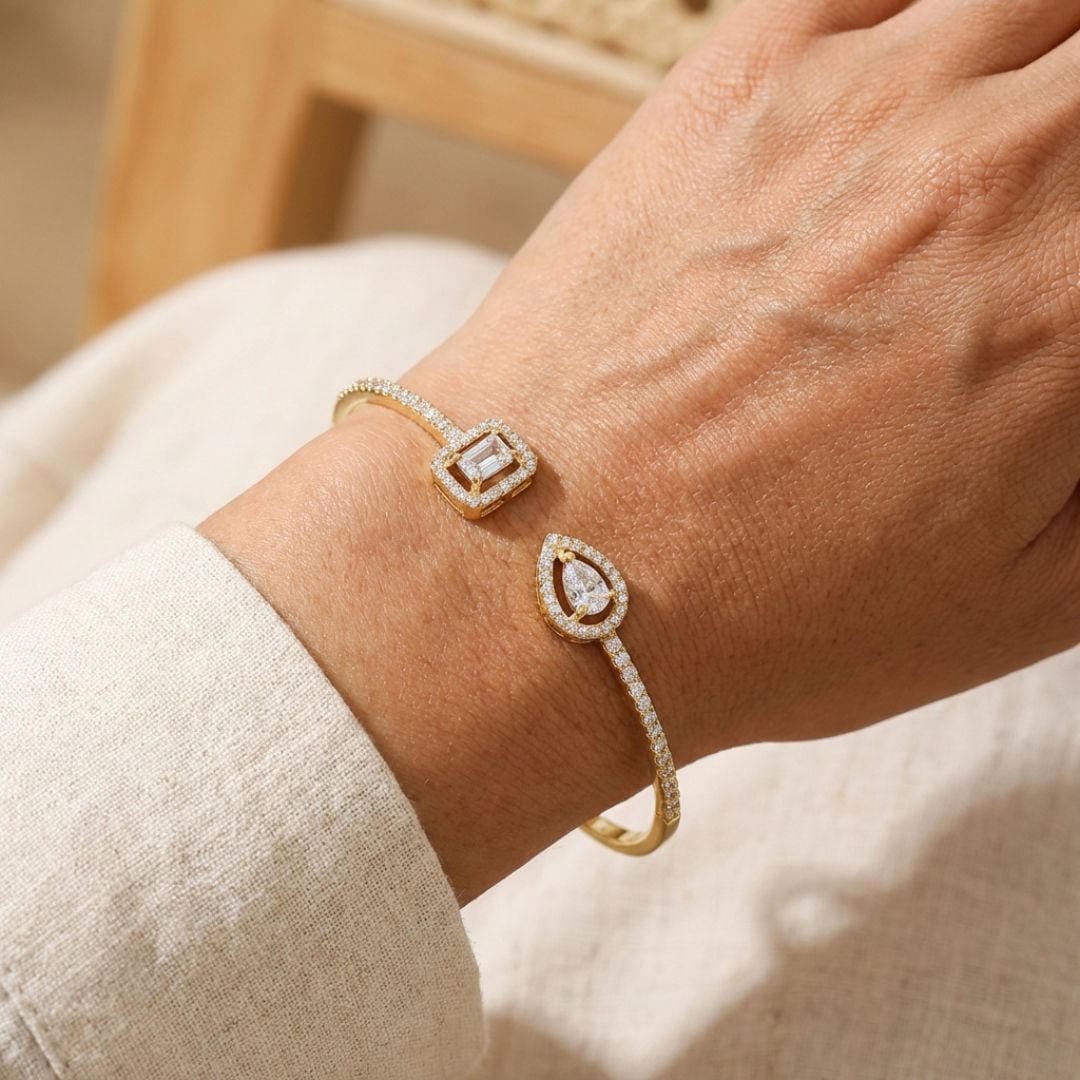 Open gold bracelet with two stones