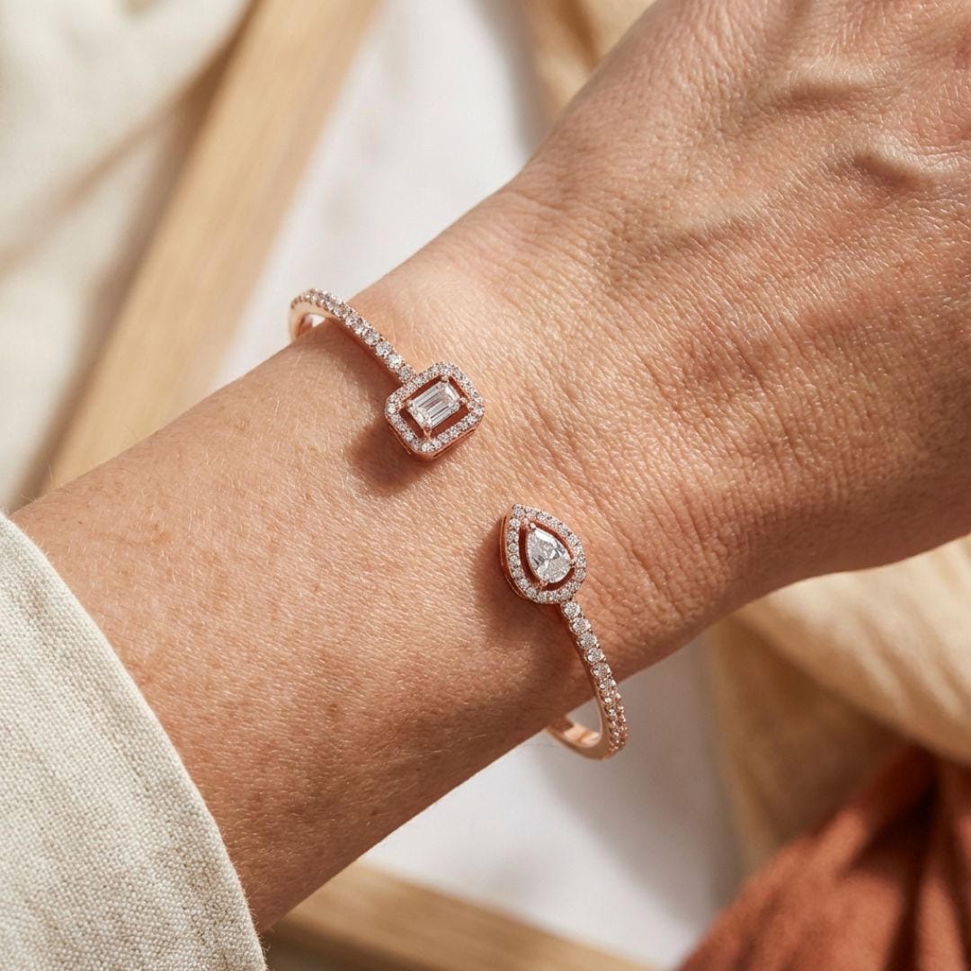 Open gold bracelet with two stones