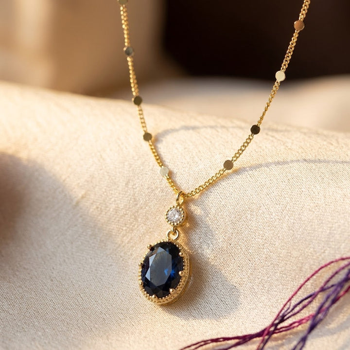 Gold necklace with oval sapphire pendant