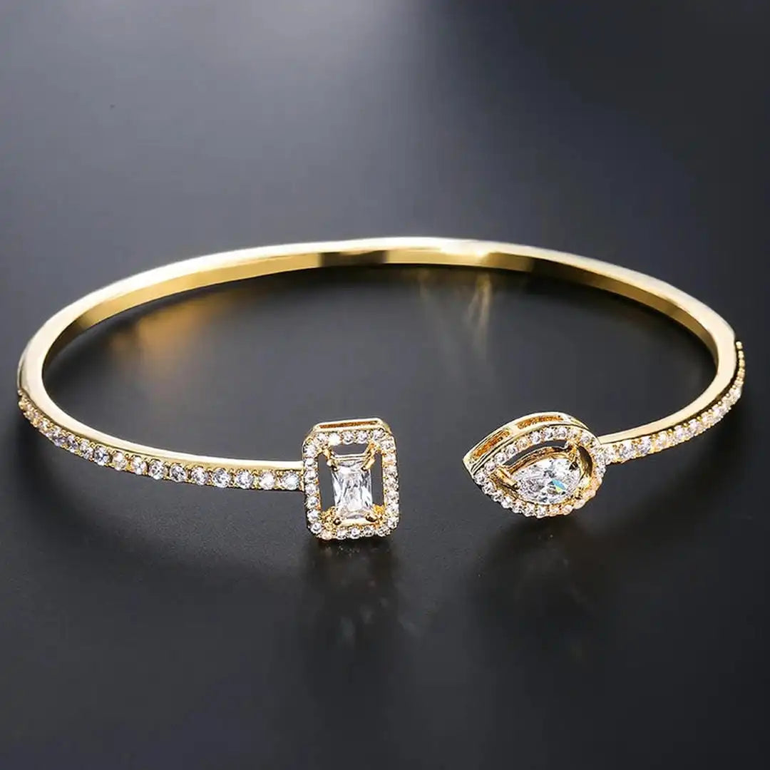Open gold bracelet with two stones