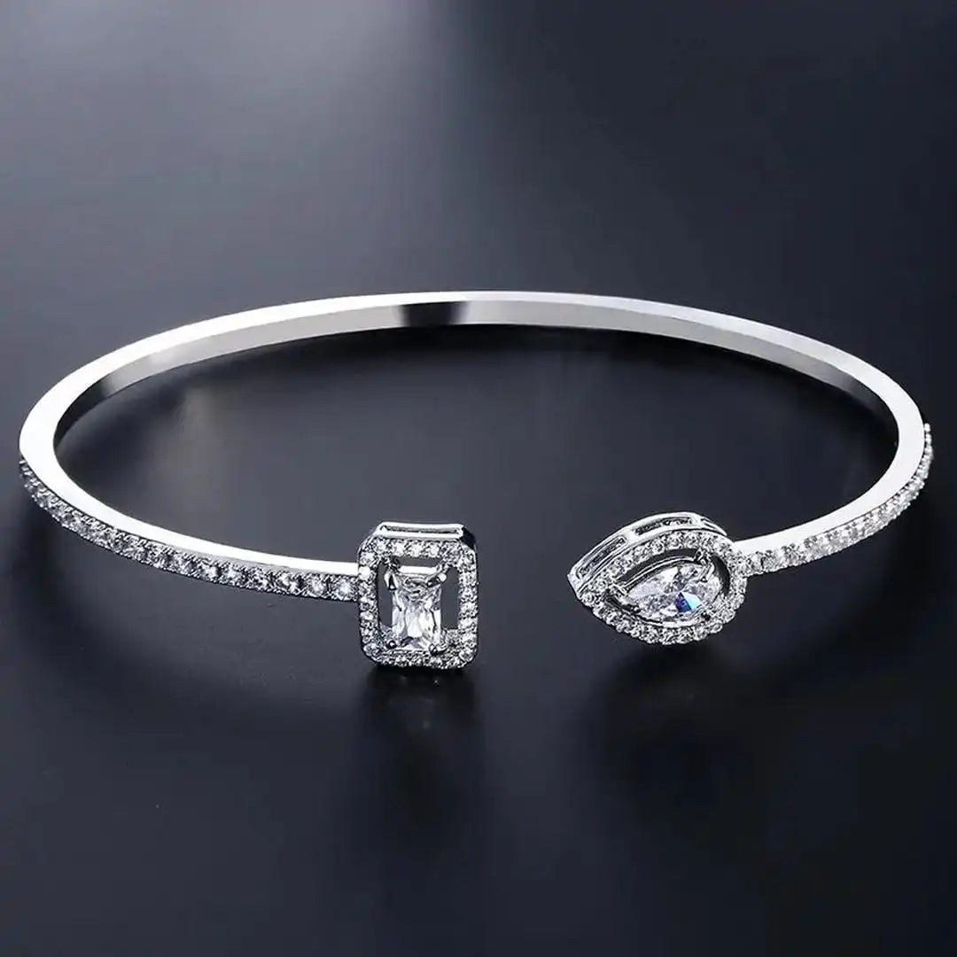 Open gold bracelet with two stones