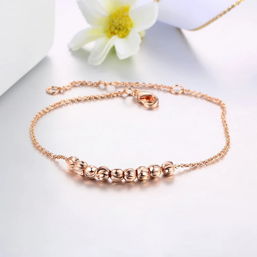 Bracelet classique en or rose lisse avec perles rondes